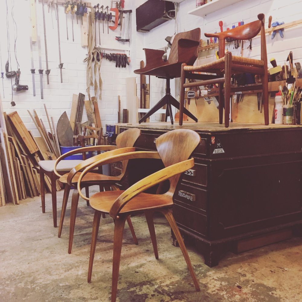 A selection of Danish and North American, Iconic, designer, Mid Century Chairs in the workshop